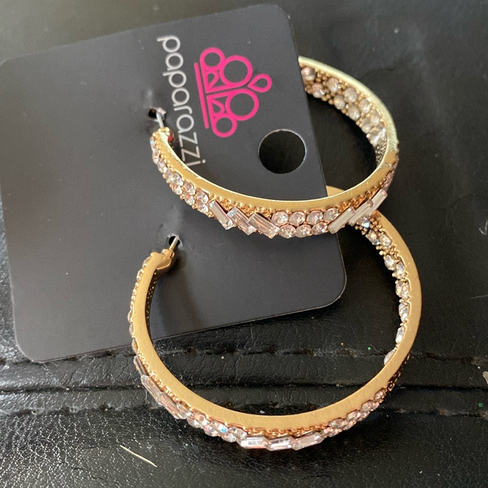 Purchased new never worn . Gold hoops with Cz accents